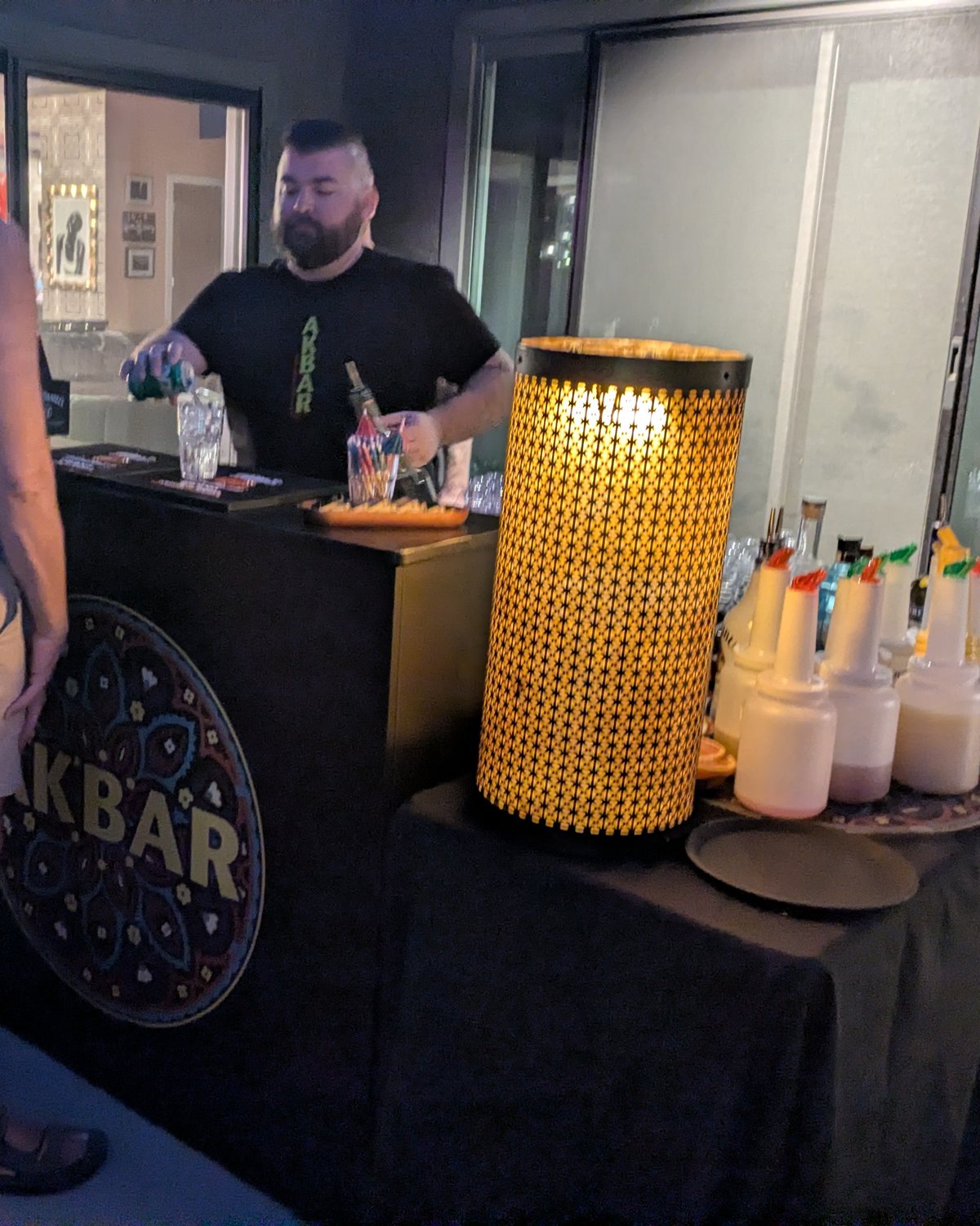 Akbar Caters - cocktails poured at an evening patio party